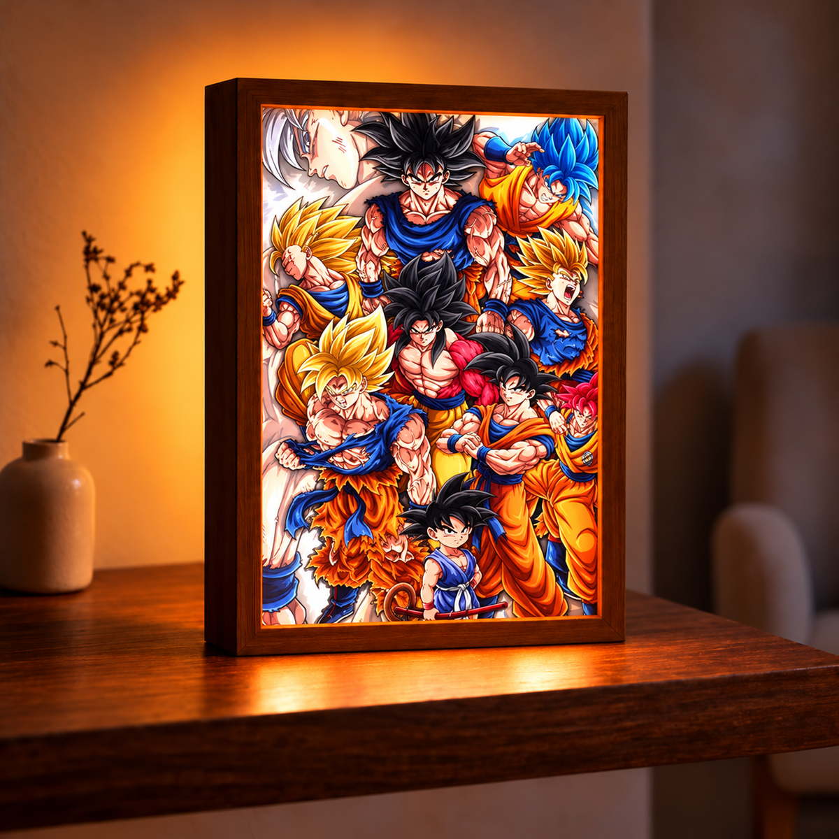 Goku Evolution illuminated artwork in a dark wood-tone frame on a wooden table, showing a vivid collage of Goku's forms in a warmly lit room