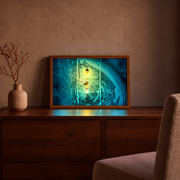 Spirited Away Lantern Path illuminated art in a wooden frame on a cabinet, with teal water and a warm yellow lantern illuminating Chihiro