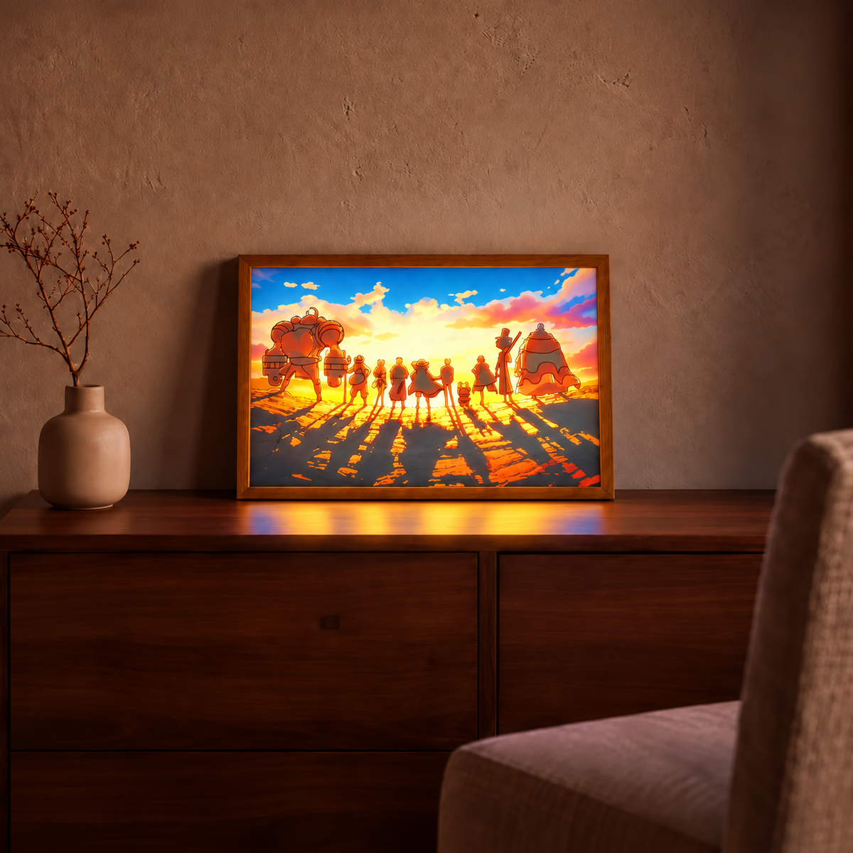 Straw Hat Crew illuminated sunset artwork in a natural wood frame on a walnut cabinet beside a beige vase in a warm living room